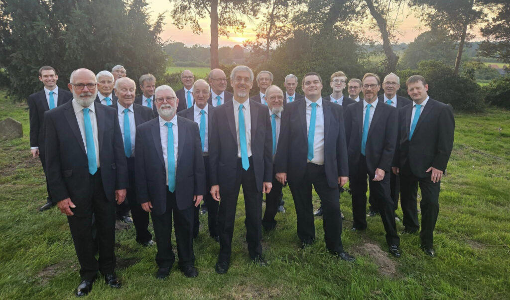 a group of nice men in ties in a churchyard at sunset